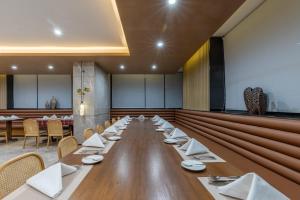 a long dining room with a long table and chairs at Pan Pacific Suites Nairobi in Nairobi +40 photos