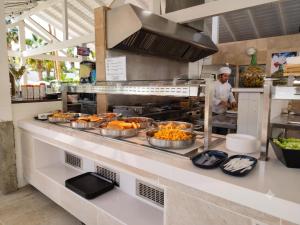 a kitchen with several pans of food on a counter at Hotel Best Tenerife in Playa de las Americas