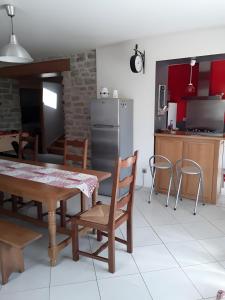 a kitchen and dining room with a table and chairs at Gîte Bourgeois in Isches