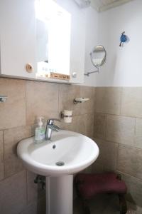 a bathroom with a white sink and a mirror at Paradiso in Firopótamos +28 photos
