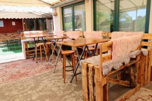 a restaurant with wooden tables and chairs and windows at Hotel & Wirtshaus Hansen in Bergisch Gladbach