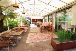 an outdoor patio with tables and chairs and windows at Hotel & Wirtshaus Hansen in Bergisch Gladbach