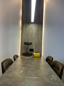 a table with chairs and a yellow box on it at Tale Coast Apartments in Tale