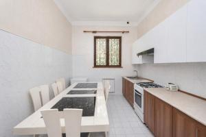 a kitchen with a table and a stove top oven at Garden Hostel 16 in Yerevan