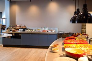 a kitchen with a buffet of food on a table at Hampton By Hilton Budapest City Centre in Budapest