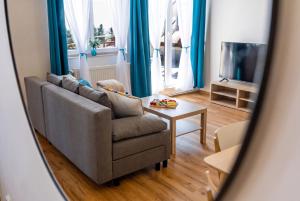 a living room with a couch and a table at Chata u kostela in Kořenov