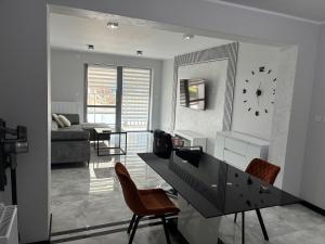 a living room with a desk and a clock on the wall at Legowisko nad Legą Centrum Olecka in Olecko