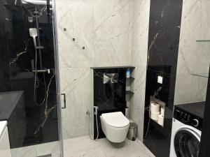 a bathroom with a toilet and a glass shower at Legowisko nad Legą Centrum Olecka in Olecko