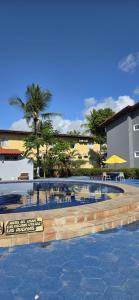 a swimming pool in a resort with palm trees at Golden Dolphin Taperapuan Apt 529 in Porto Seguro