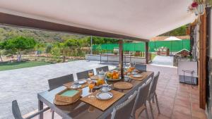 a table with food on it on a patio at Villa Andrea Comares in Comares