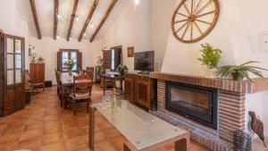 a living room with a fireplace and a table at Villa Andrea Comares in Comares