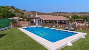 a swimming pool in the yard of a house at Villa Andrea Comares in Comares