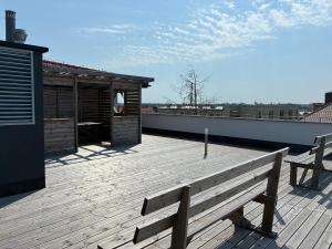 a wooden deck with a bench on a roof at Legowisko nad Legą Centrum Olecka in Olecko