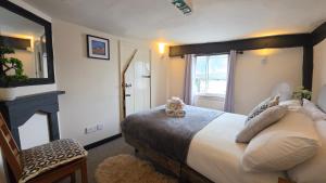 a bedroom with a large bed and a window at Ye Olde Red Horse in Evesham