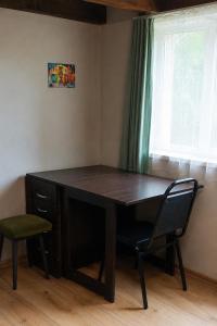 a desk in a room with a chair and a window at Welcome Guests in Tbilisi City +15 photos