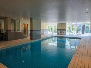 a large swimming pool in a large building at Onyx - 1 5 Zimmer in Muralto
