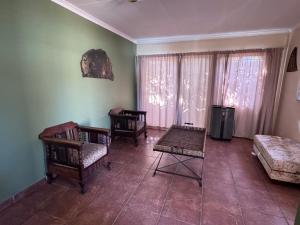 a living room with two chairs and a couch at Kalahari Hotel in Olifantshoek