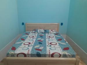 a bed with a comforter with a camera on it at An Loc Motel in Vĩnh Long +40 photos