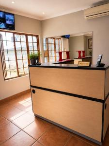 a restaurant with a counter with a phone on it at Wampex Guesthouse in Potchefstroom