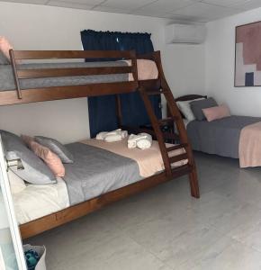 a room with two bunk beds in a room at Armonia Rosada in Cabo Rojo