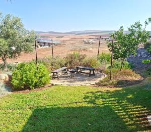a picnic table and a bench in a field at Workation experience in beautiful village in Temarah