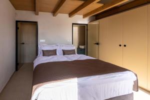 a bedroom with a large bed in a room at Persolis luxury sun residence in Kojsko