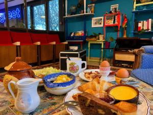 a table topped with plates of food and eggs at Greet hôtel Saint-Nazaire-Trignac, Nouvelle marque du groupe Accor in Saint-Nazaire