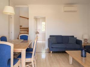 a living room with a table and a blue couch at Ona Village Cala d'Or in Cala d´Or