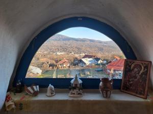 a window in a building with a view of a town at Maramureș Nook in Comarnic +16 photos