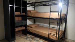 a room with two bunk beds and a lamp at My Backpacker House in Gili Trawangan