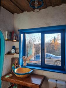 a bathroom with a bowl sink and a window at Maramureș Nook in Comarnic