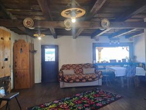 a living room with a couch and a table at Maramureș Nook in Comarnic