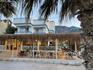 a restaurant with tables and chairs in front of a building at ADAYELI BUTIK HOTEL in Karaburun