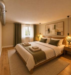 a bedroom with a large bed with two towels on it at Art Residence, Beat Schild in Brienz