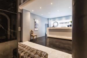 a dressing room with a bench and a table at ONOMO Hotel Foreshore in Cape Town