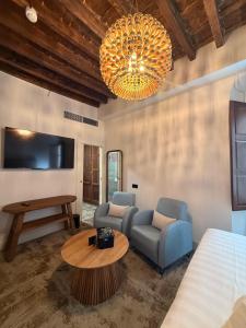 a living room with two chairs and a table at 4U Hostel in Granada