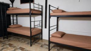 two sets of bunk beds in a room at My Backpacker House in Gili Trawangan