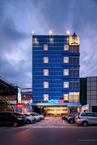 a hotel building with a clock on top of it at Hotel 88 Mangga Besar Raya 120 Jakarta By WH in Jakarta