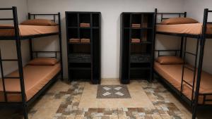 three sets of bunk beds in a room at My Backpacker House in Gili Trawangan