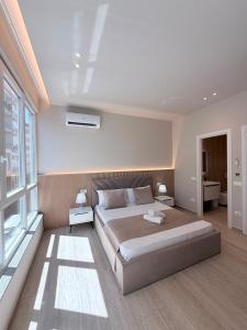 a bedroom with a large bed and a window at Todo Luxury Suites in Durrës