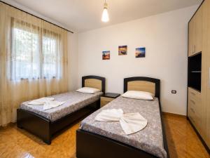 a room with two beds in a room at Villa Ajla- Entire Villa in Durrës