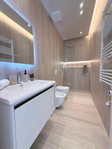 a bathroom with a sink and a toilet and a shower at Todo Luxury Suites in Durrës