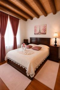 a bedroom with a bed with a swan on it at Rustic Cottage in Sibiu