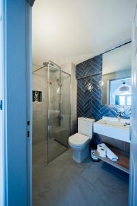 a bathroom with a toilet and a sink and a shower at ADAYELI BUTIK HOTEL in Karaburun