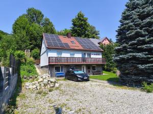 a house with solar panels on the roof at Penzion Pomněnka in Lipova Lazne