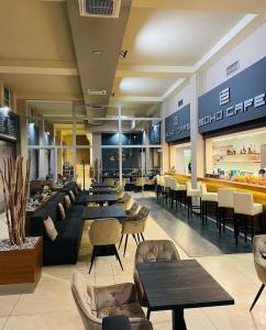 a restaurant with couches and tables and chairs at Soho apartment in Písek