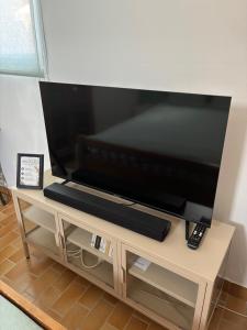 a flat screen tv sitting on top of a tv stand at Casa Geco in Flayosc