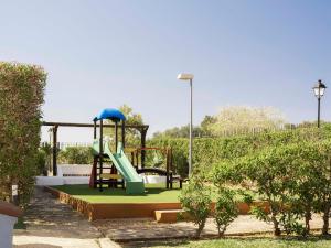 a playground with a slide in a park at Ona Village Cala d'Or in Cala d´Or