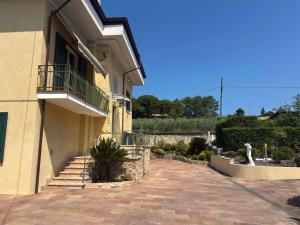 a building with stairs and a balcony on it at Villa Mario in Senigallia