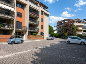 two cars parked in a parking lot in front of a building at Casa Moscati in Avellino